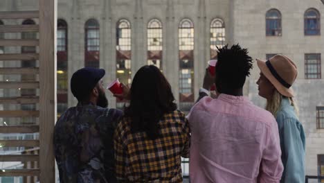 Young-adult-friends-hanging-out-on-a-rooftop