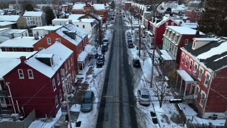 icy road in american town with snow covered roofs