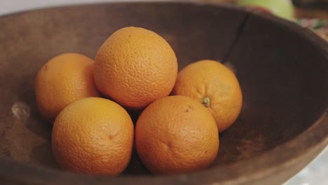 panning shot of a bowl of oranges