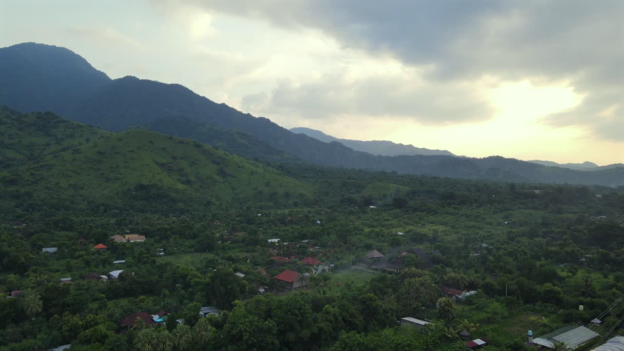 Bali rural village countryside lush green vegetation canopy over landscape, aerial drone Indonesia