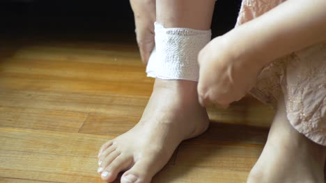 Woman-with-bandaged-foot-on-bed