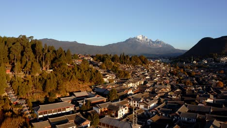 Lijiang-city-old-town-and-Jade-Dragon-Snow-Mountain,-Yunnan-China,-aerial-view