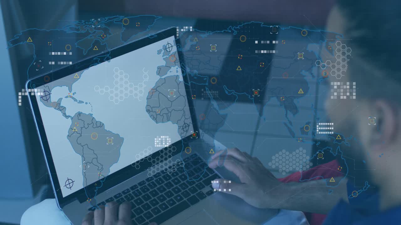 animación del mapa del mundo sobre un hombre de negocios biracial usando una computadora portátil.