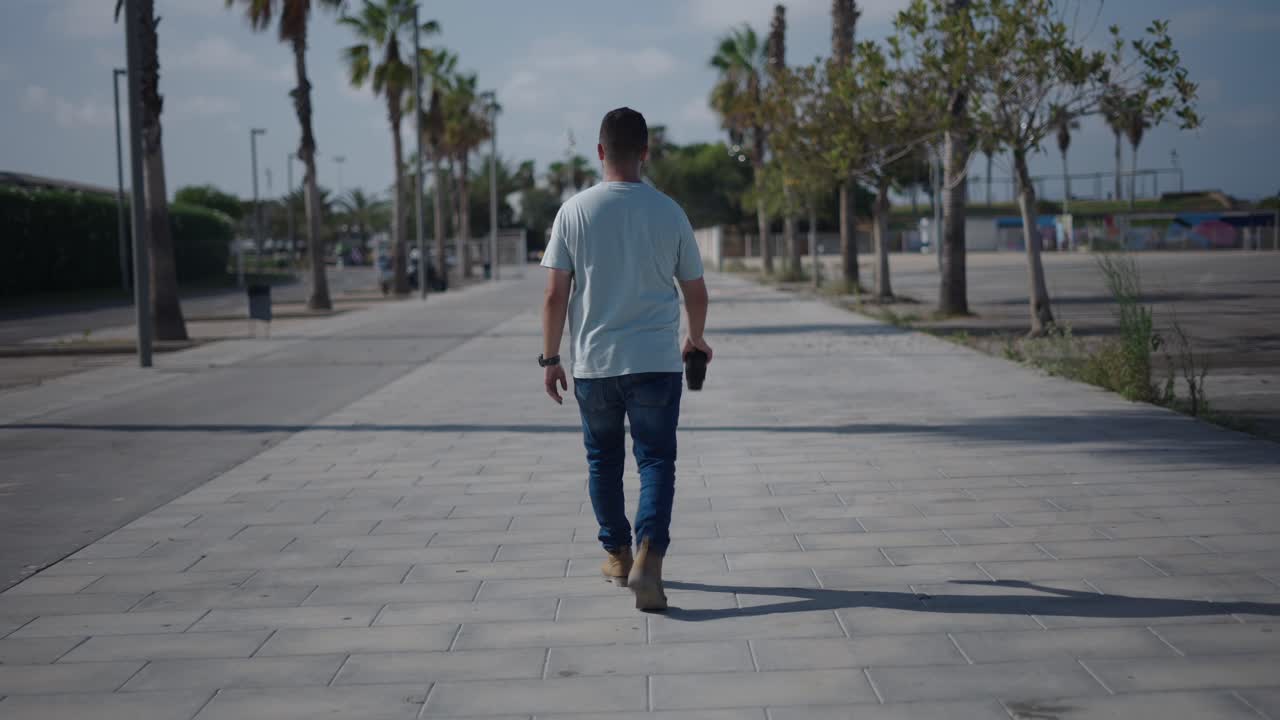 Man Walking Down a City Path