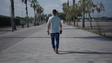 man walking down a city path