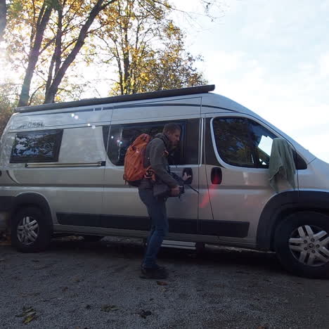 Traveling-vlogger-leaving-conversion-van-for-hike-in-woods-of-Eifel-Germany