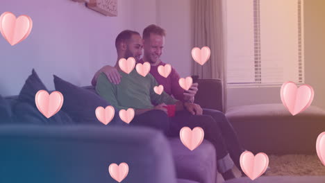 animation of heart icons over happy diverse gay couple embracing