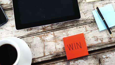 coffee cup, digital tablet, mobile phone, sticky note on wooden plank