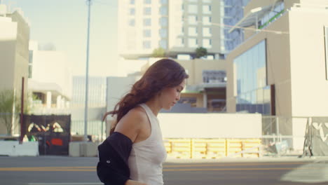 businesswoman taking off jacket going down street. asian woman walking on avenue