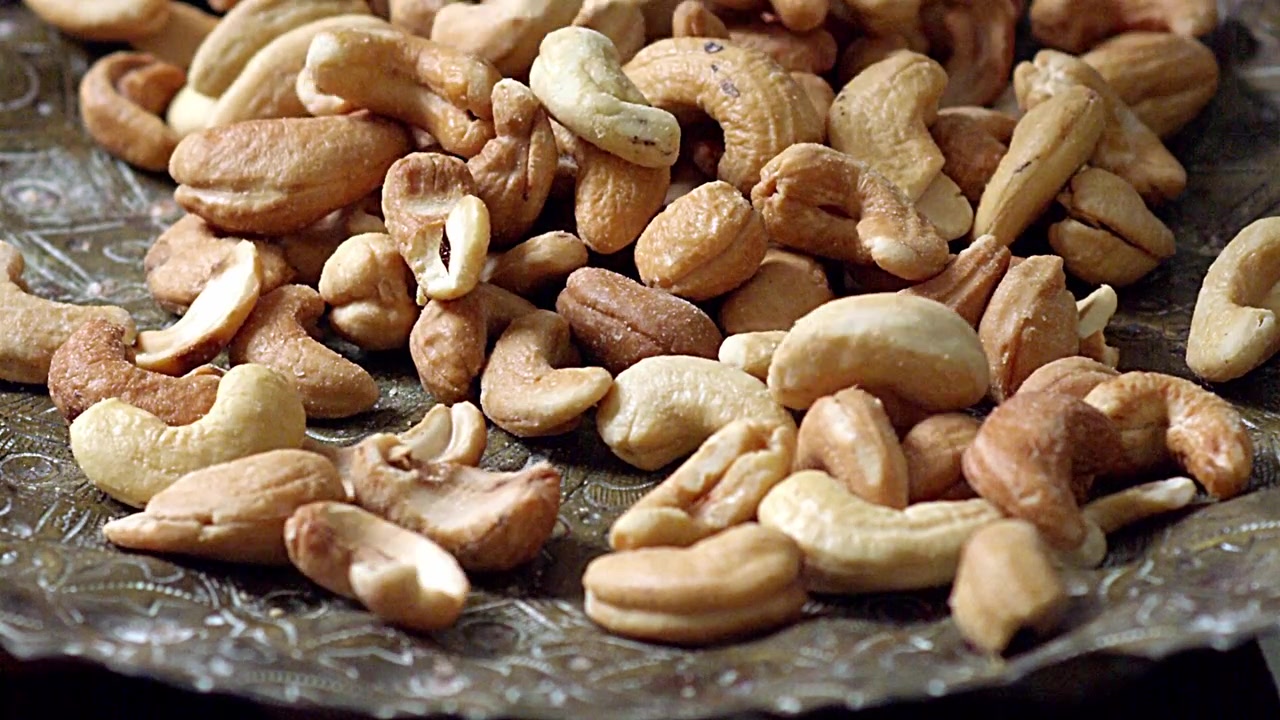 Tasty cashew nuts, smooth and light, a golden treat, a salty bite