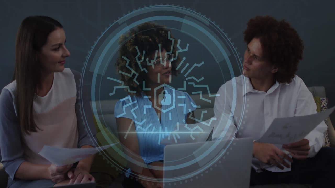 Animation of cyber security text, security padlock icon over diverse colleagues discussing at office
