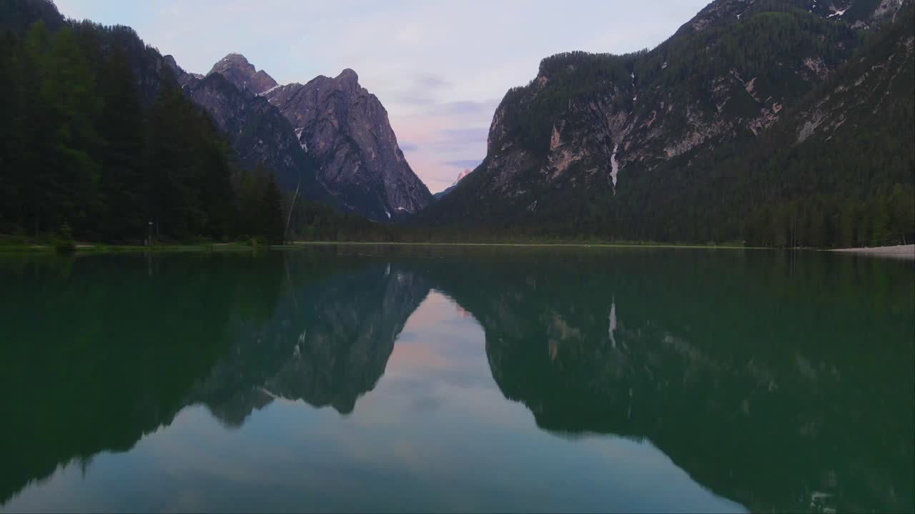 Lake Dobbiaco and deep forest in Toblacher See, South Tyrol, Italy