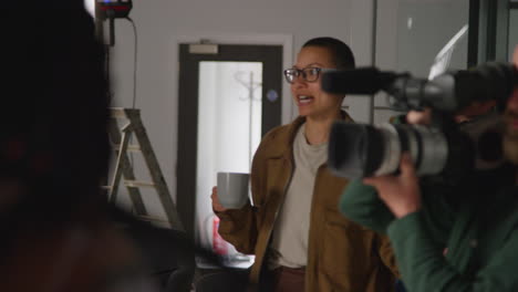 woman being interviewed on a film set