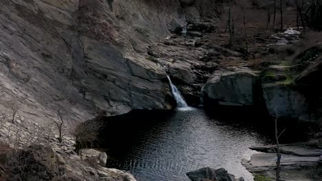 high drone flight over water in near of a waterfall at daytime