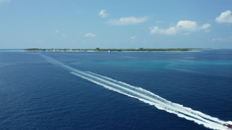 boat crossing with in the background dharavandhoo island in the maldives