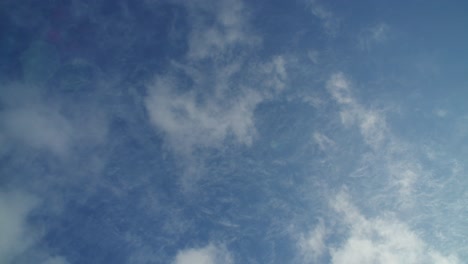 time-lapse looking straight up as clouds race by overhead