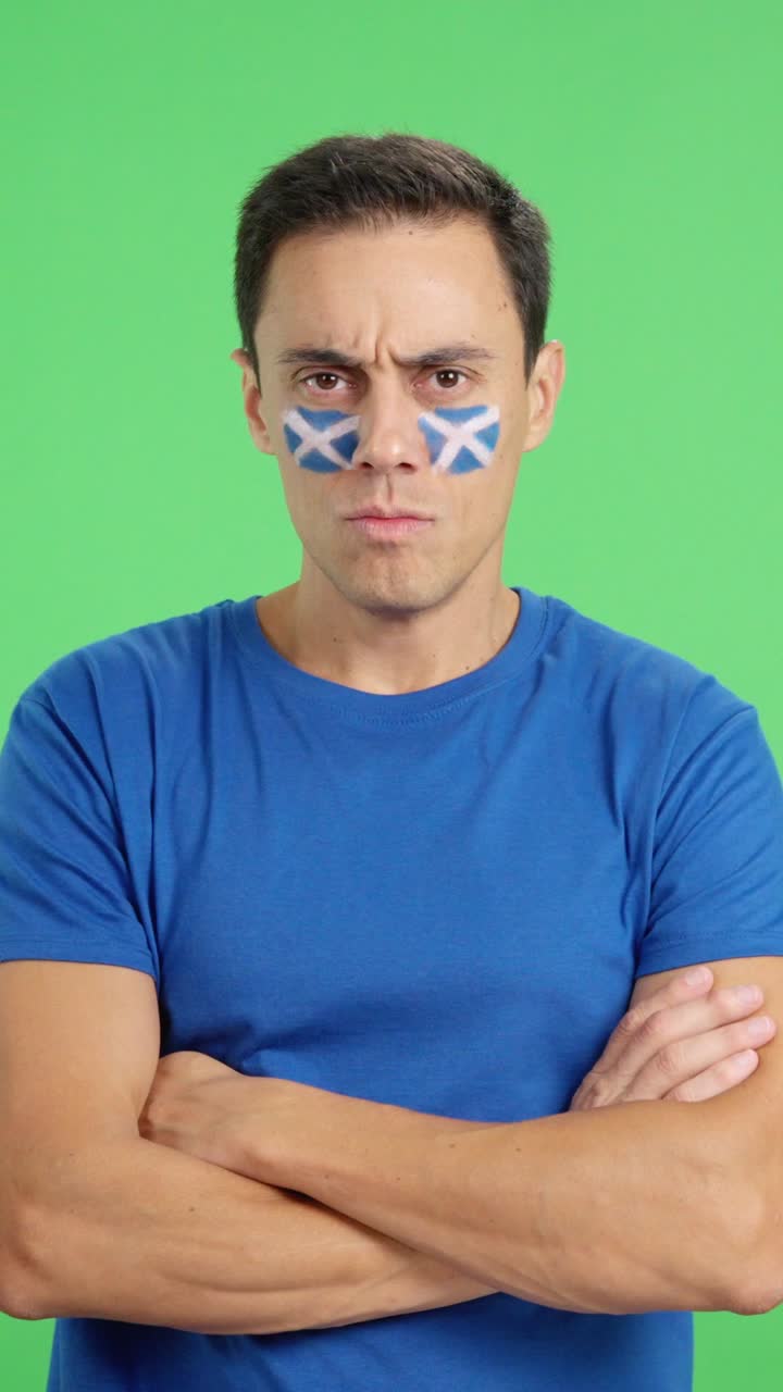 Dignified and serious man with scottish flag painted on face