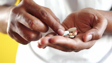 Close-up-of-man-hand-holding-pills-with-copy-space