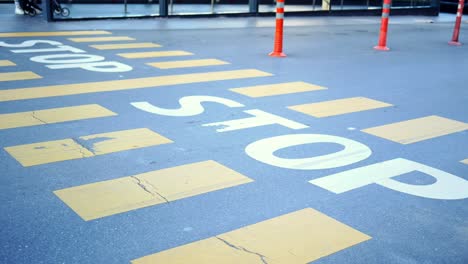 a pedestrian crossing sign with the word 'stop' painted on it