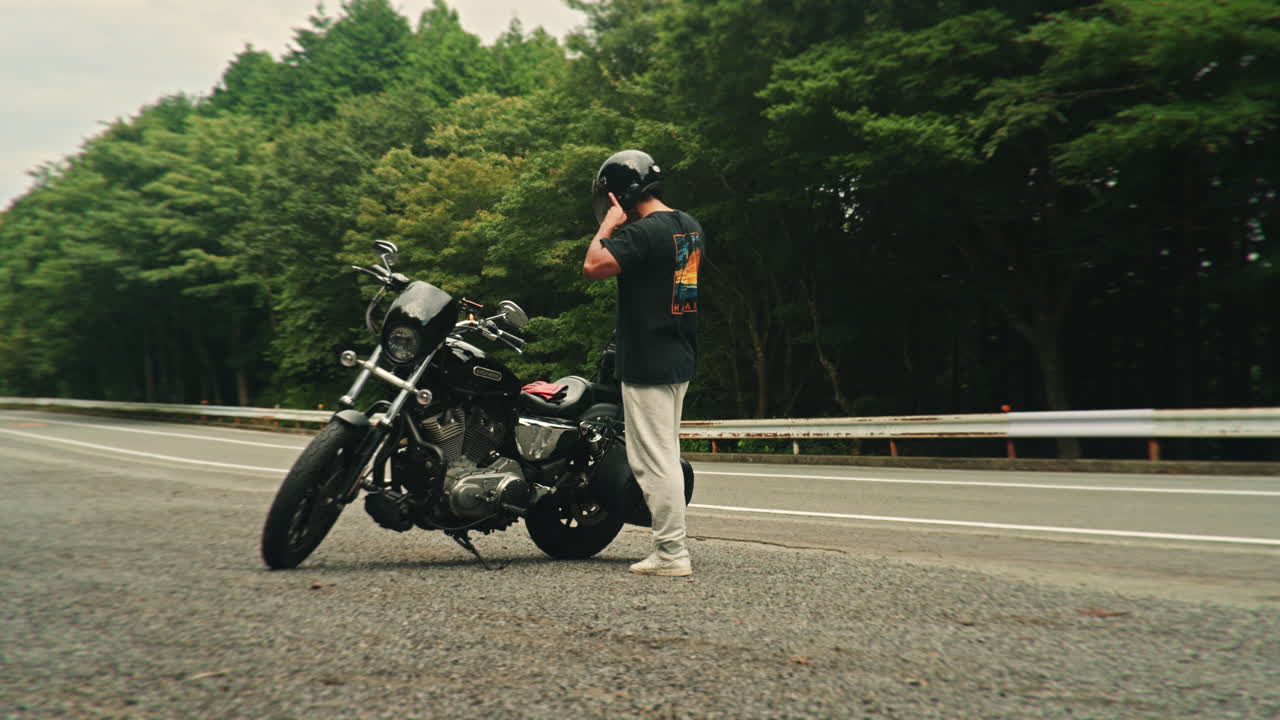 Man with Motorcycle on the Road