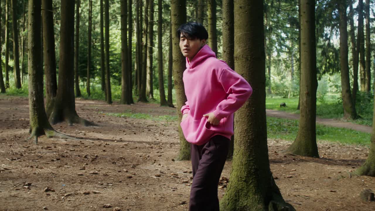 Person in a pink hoodie in a forest