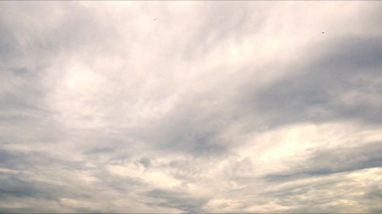 Timelapse of dramatic cloud formations moving across an open sky, creating dynamic natural patterns and changing atmospheric conditions.