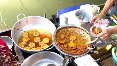 vendor prepares crispy mussel pancakes in bangkok