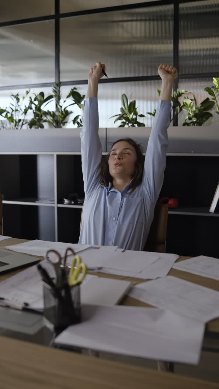 Woman Working and Stretching in Office