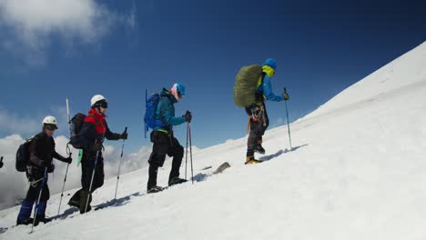 mountain climbers ascending a snow-covered peak