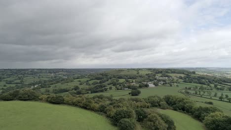 aerial tracking forward over a hill in east devon