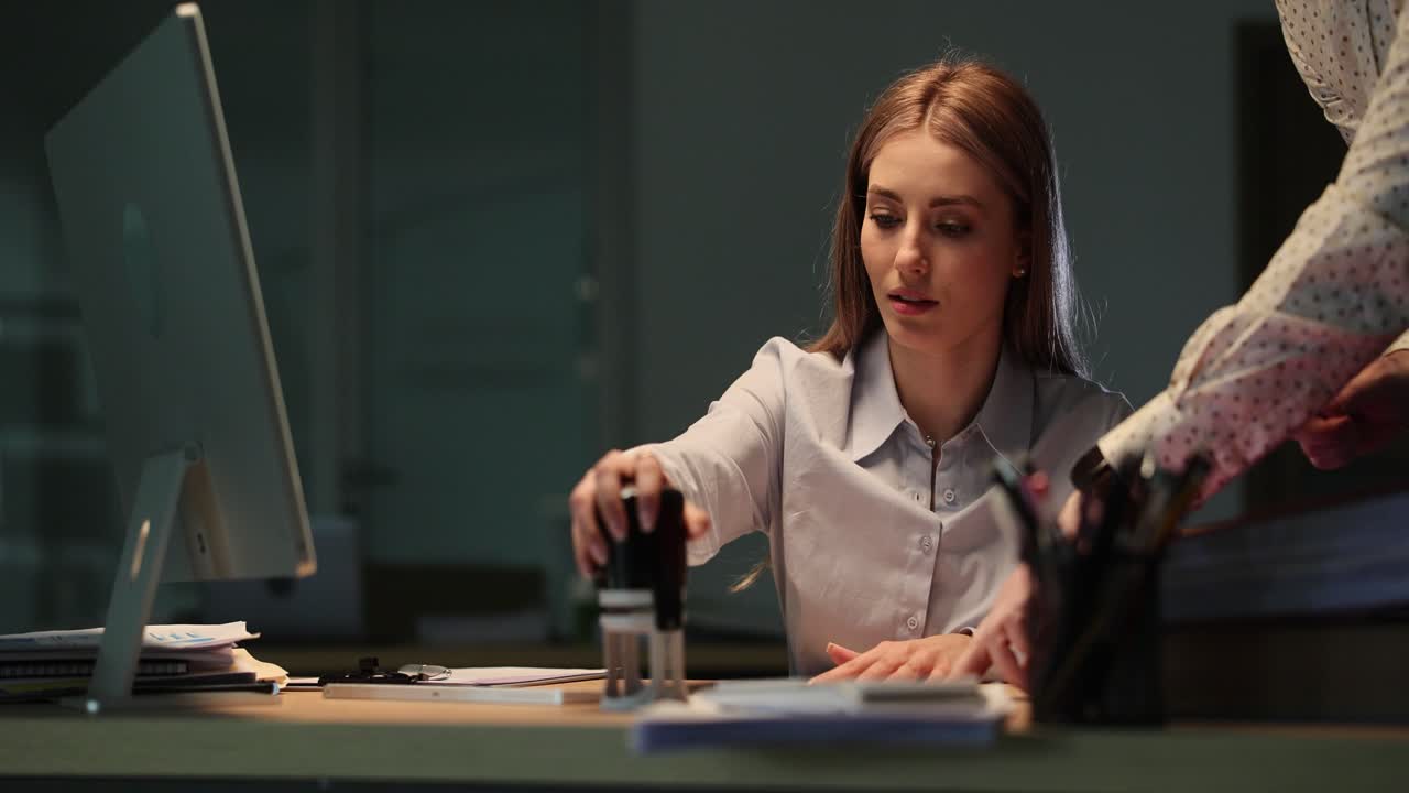 Woman Stamping Documents in Office