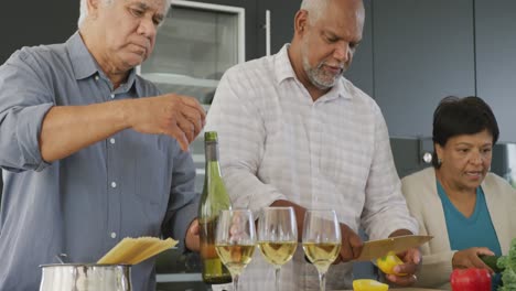 happy senior diverse people cooking in kitchen at retirement home