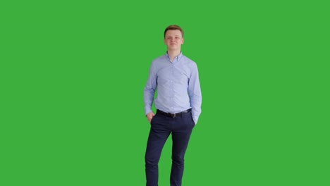 young handsome men acting in front of a green screen. blond hair, blue shirt and blue trousers. dancing, thinking, turning around and talking to the camera.