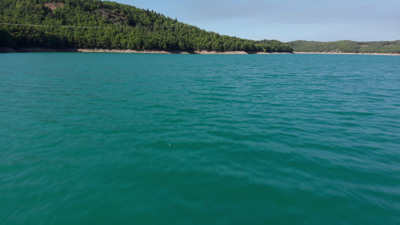 Aerial Drone Video Over Lake Plastiras Dam Close to Water on Sunny Day