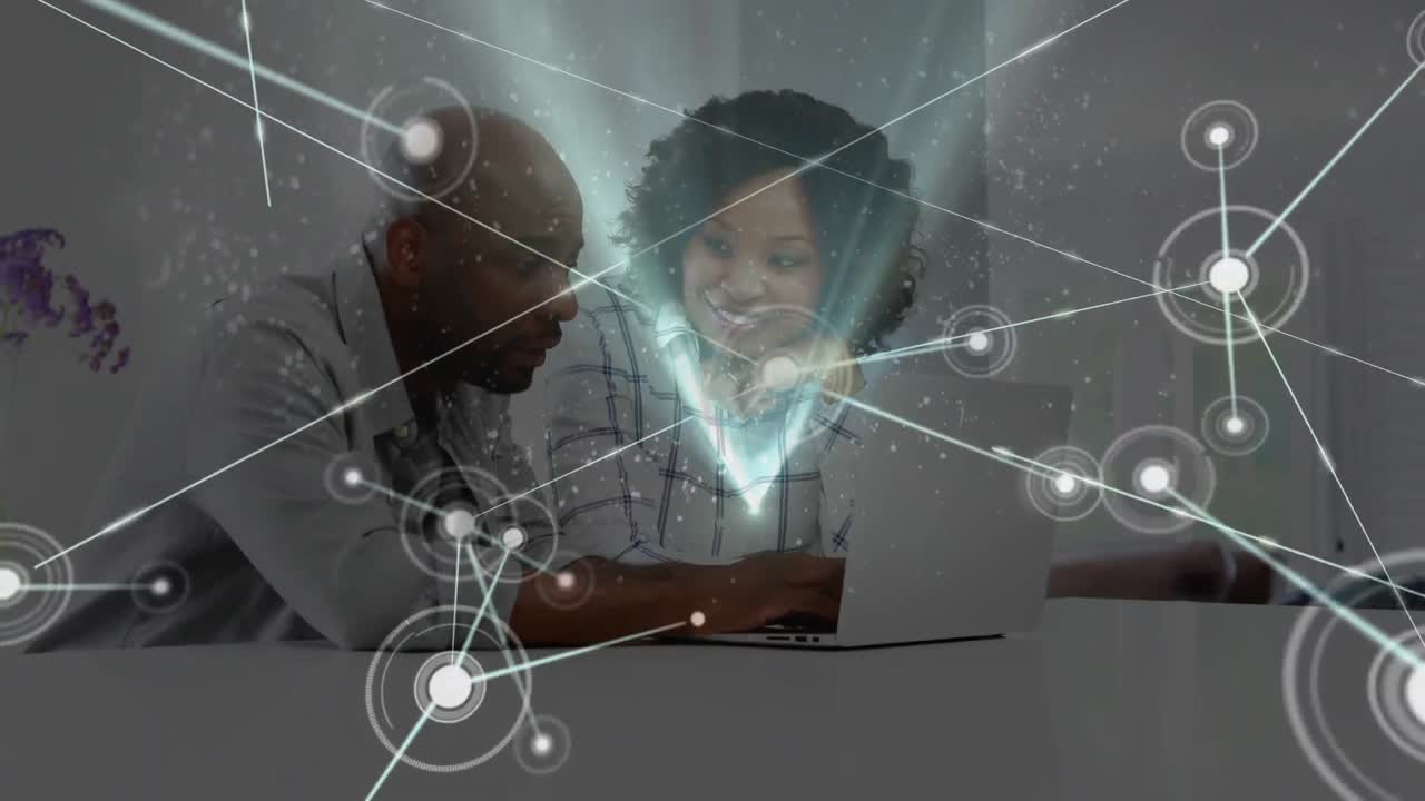 Animation of network of connections over people using laptop