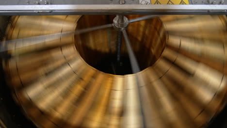 honey extraction with the help of electric centrifuge device. wooden frames with honeycombs spin to get rid of honey. top view.