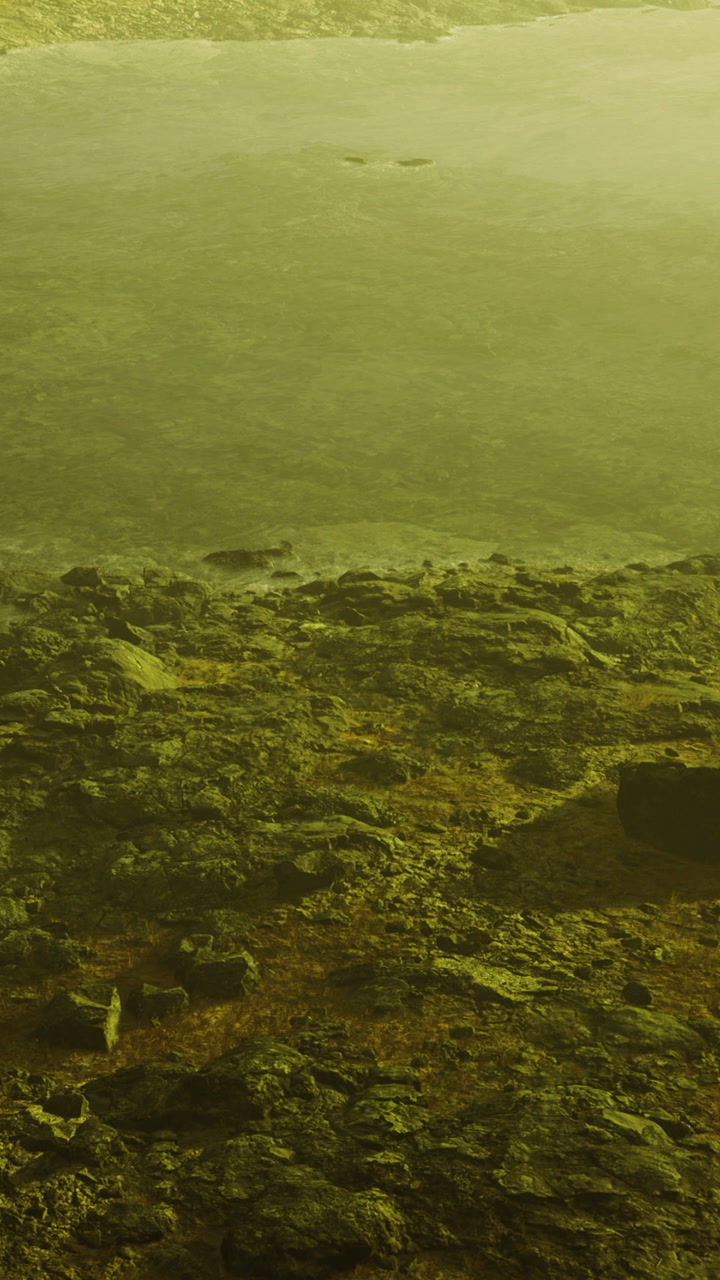 Scenic view of rocky shoreline under hazy conditions at dawn