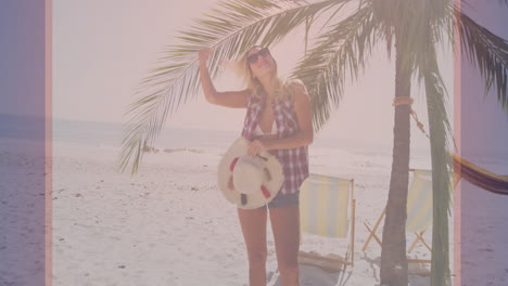 wearing sunglasses and holding hat, woman relaxing under palm tree on beach