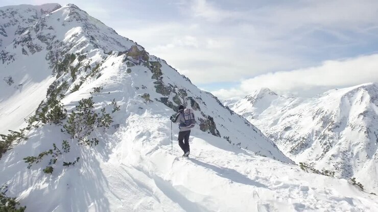 Hiker in Snowy Mountains