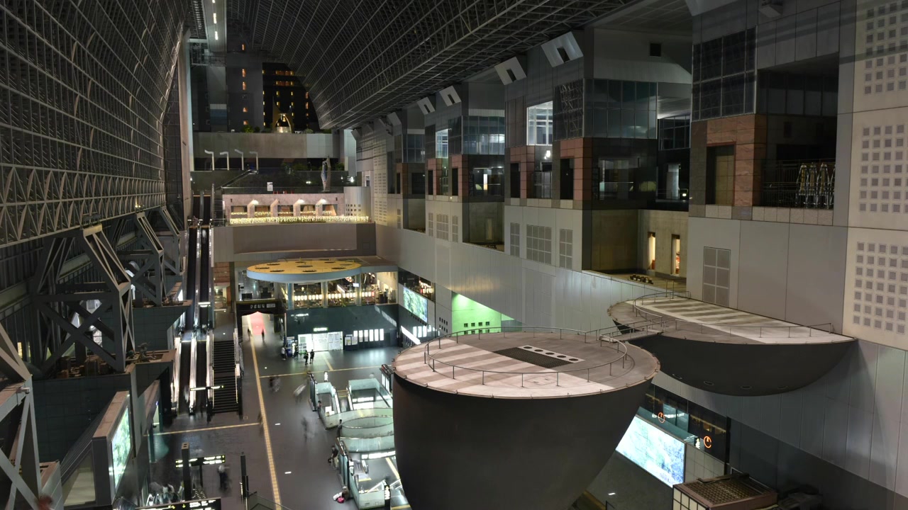 Kyoto Station, Japan’s main railway hub, served by Japan Railways including the Shinkansen bullet train. This modern station features busy platforms and iconic architecture.