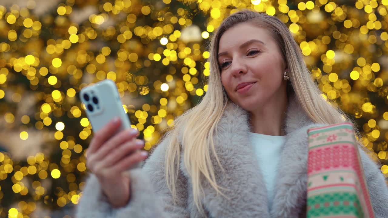 Woman with Christmas Gift and Phone