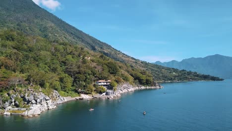 local fisherman boats paddling and a beautiful day in lake atitlan, guatemala - drone aerial view