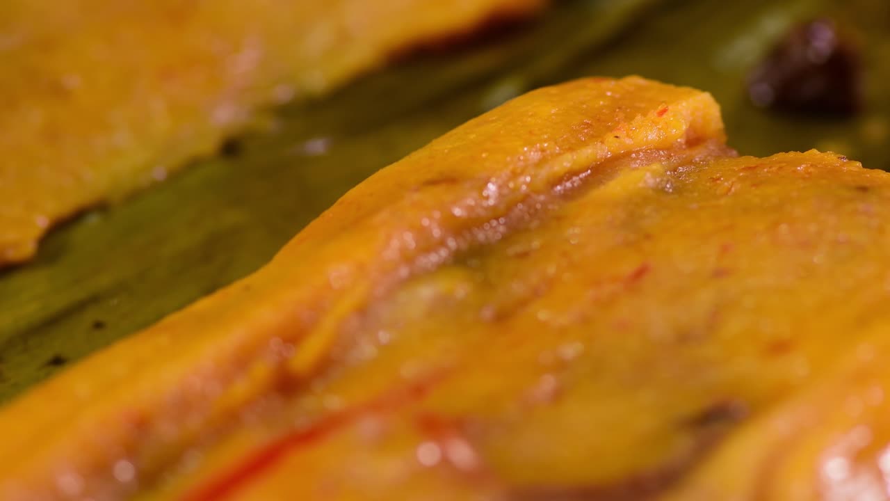 Dramatic slow-motion close-up of a Hallaca cut open, rotating 360 degrees to showcase the moist texture and rich, savory guiso filling