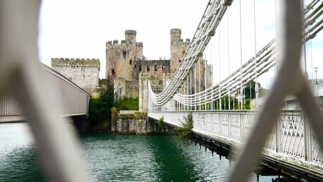 Conwy-castle-steel-walkway-landmark-north-Wales-river-suspension-bridge-slow-pull-back