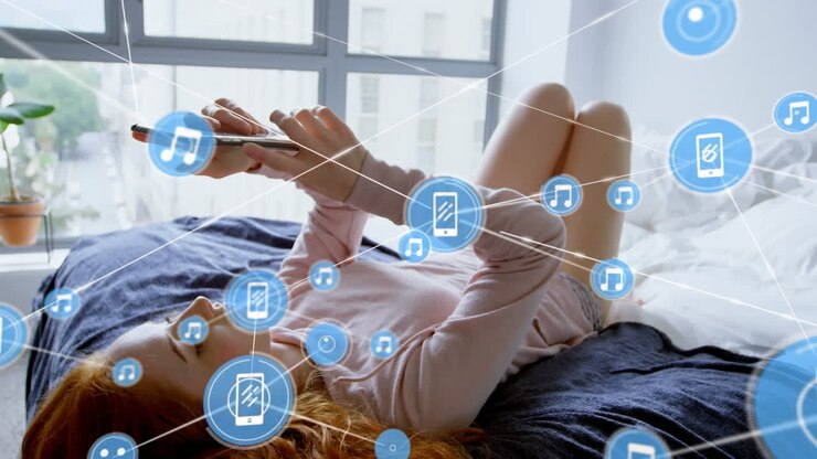 Animation of network of digital icons over caucasian woman using smartphone lying on the bed at home