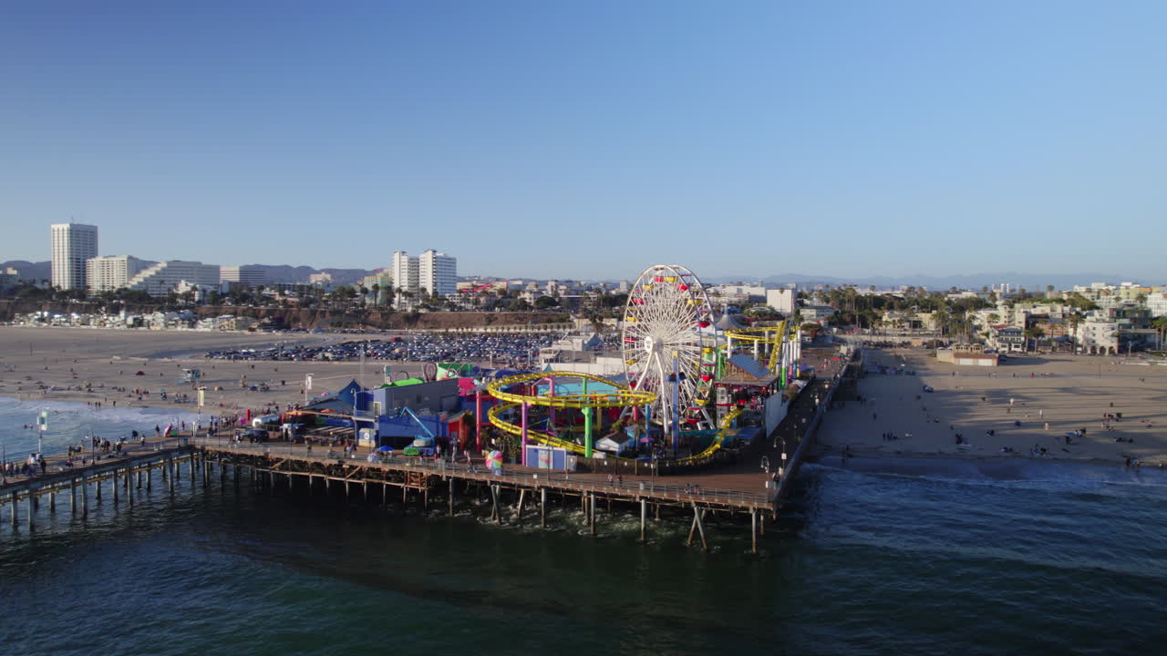 Santa Monica Pier late afternoon in the summer orbiting drone shot