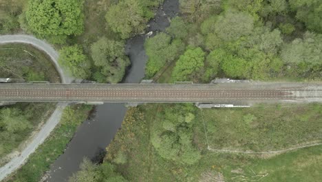 topdown view of railway bridge over green valley in county kerry in ireland
