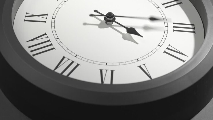 Latin Clock Face in Time Lapse on Dark Grey Wall