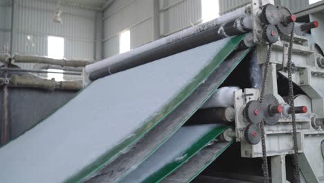 sheets of cotton rolled out flat in factory