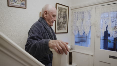 elderly man in robe near doorway
